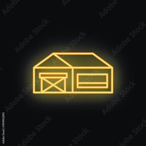 Yellow neon sign of an industrial building with a large sliding door and a smaller entrance is glowing in the dark