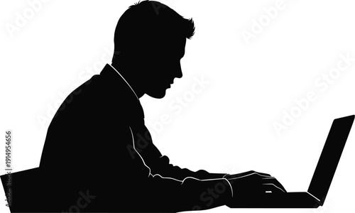 Businessman silhouette typing intently on a modern open laptop computer.