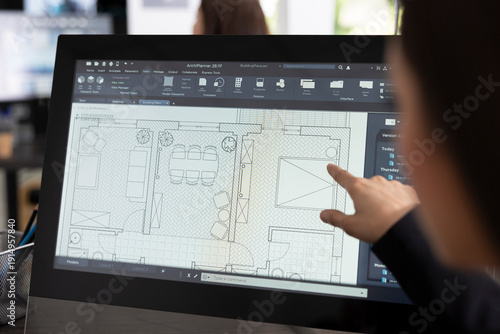 Obraz na plátně Female creative designer sketching architectural floor layout on digital device, preparing for new construction project