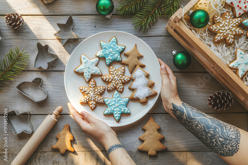 Hands holding plate of christmas cookies