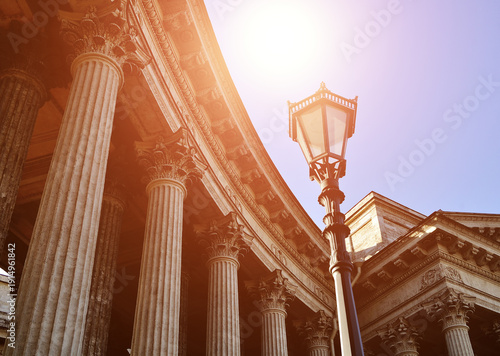 Saint Petersburg, Russia, Kazan Cathedral, classical colonnade and metal vintage lantern under shining sunset light against blue sky