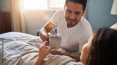 Caring husband bringing his wife morning coffee in bed.