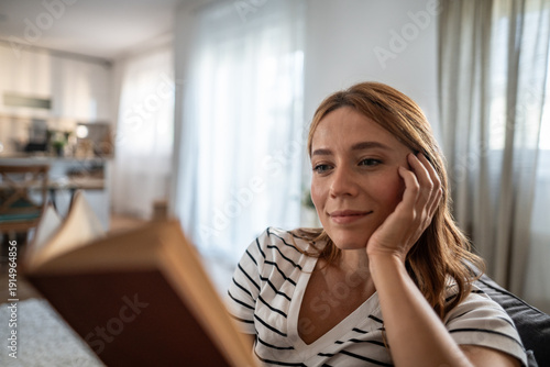 Woman enjoying a quiet moment reading a book at home Free Download Woman enjoying a quiet moment reading a book at home - GFXLoad