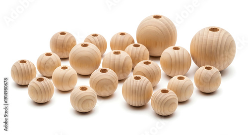 A collection of natural light-colored wooden spherical beads with holes, arranged on a clean white background, showcasing their varied sizes and wood grain.