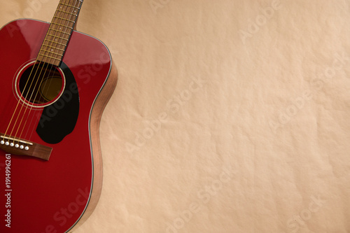 Fotografie Red Acoustic Guitar Focused on String Adjustment and Maintenance Repair Concept