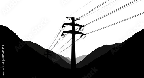 High voltage transmission tower silhouette between mountain ridges