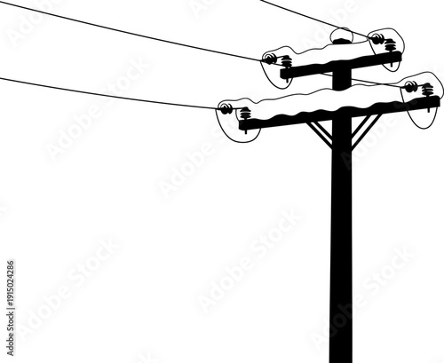 Winter utility pole silhouette with snow accumulation on crossarms