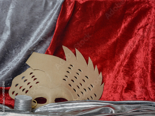 Background with a cardboard mask and red velvet