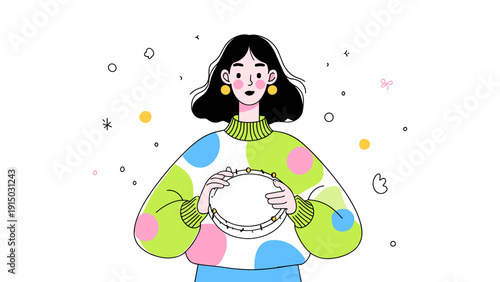 Young woman with black hair holding a tambourine, wearing a colorful polka dot sweater