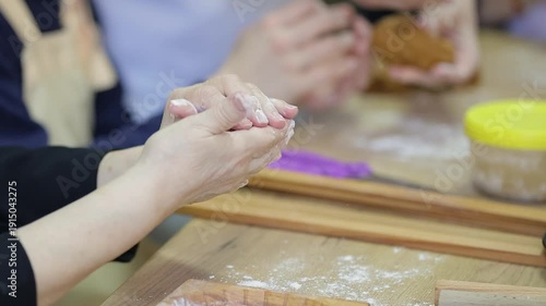 Women's hands kneading the dough. Close-up. Very soft focus