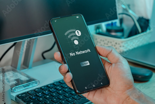 A man holding a mobile phone with No Network or No internet access notification