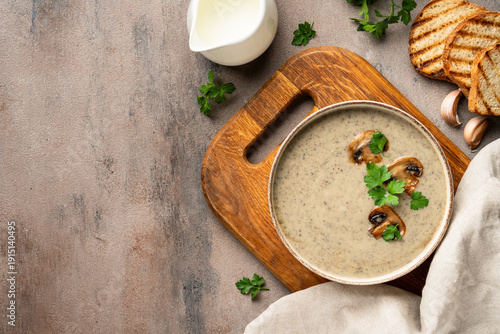 Mushroom soup puree on white kitchen table.