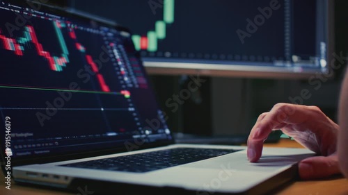 Close up: Investor laptop with a terminal, graphs and charts. Trader male hand makes stock purchases and investments in app. Cryptocurrency bitcoin, USD. Global market analysis online brokerage