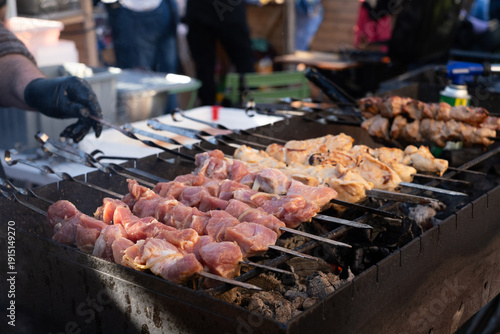 Grilled meat is sold on the street. Street food, delicious and juicy kebab cooked on an open fire at the fair