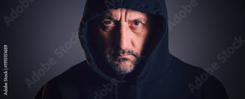 Obraz na płótnie portrait of a middle-aged man with short beard and weathered face, wearing a dar