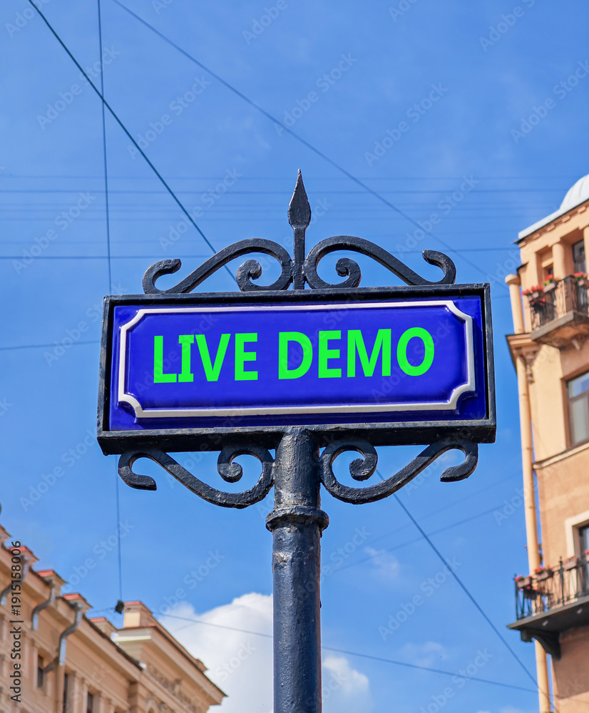 Obraz premium Live demo symbol. Concept words Live demo on beautiful big blue road sign. Beautiful blue sky and buildings background. Copy space. Business and live demo concept.