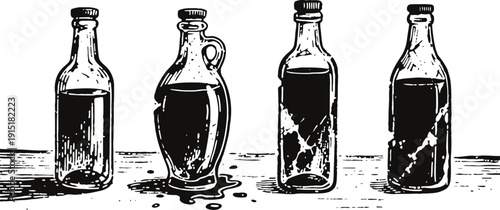 Four antique glass bottles containing liquid with reflections on a wooden surface