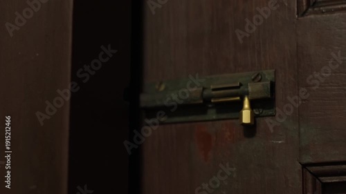 Wallpaper Mural Hand pulling a metal door bolt open creating a sharp metallic clicking sound Torontodigital.ca