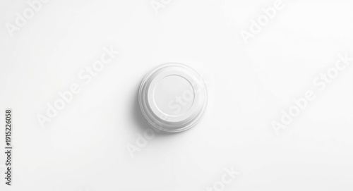 Closed white plastic lidded food container for takeaway displayed top down on white surface