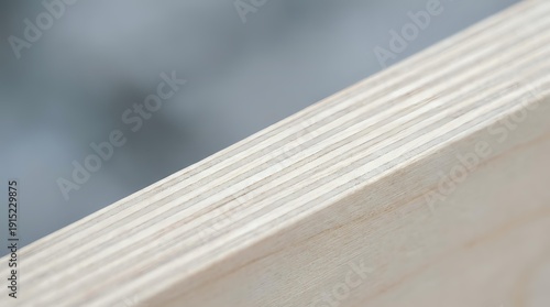 Close-up of light wood plywood edge showing layered construction and natural grain texture for carpentry and construction projects.
