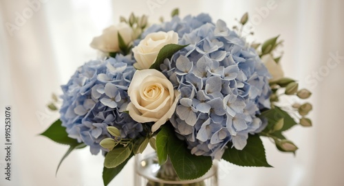 Beautiful floral arrangement with blue hydrangeas and cream roses ideal for invitation cards