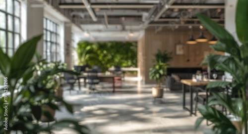 Contemporary office with soft blurred background highlighting open workspace and botanical elements