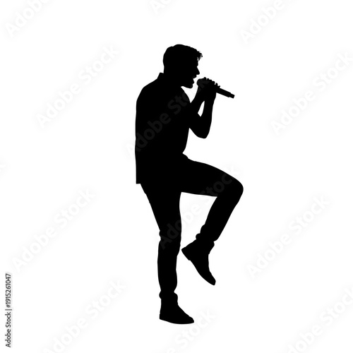 Silhouette of a male singer performing with a microphone on stage.