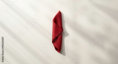 Free Download Sophisticated red napkin folded in an artistic style on a bare tabletop with plenty of room for text - GFXLoad