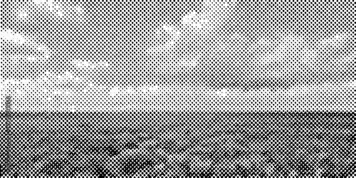 Grayscale landscape featuring a horizon line and textured sky