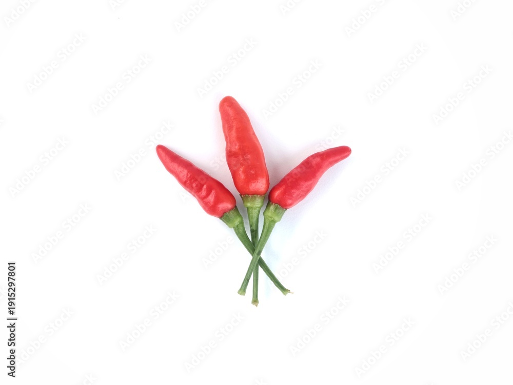 Fototapeta premium Three fresh red bird's eye chilies isolated on white background. Perfect for culinary, spicy food, and healthy ingredient themes
