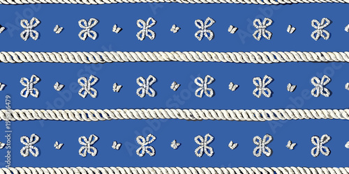 Nautical rope and decorative knot pattern on a blue background