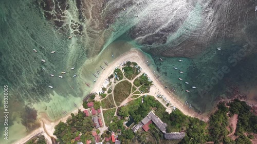 Stunning tropical shoreline with coral reef and clear turquoise water at sunrise in Sri Lanka. Low tide exposes reef patterns beneath calm ocean surface, creating peaceful and scenic marine landscape.