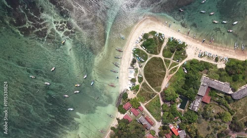 Beautiful coral reef revealed by low tide in the early morning light in Weligama. Calm azure ocean, natural reef textures visible through transparent water, and serene tropical atmosphere