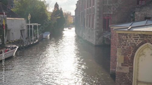 River reveal with reflections next to church in Bruges Belgium
