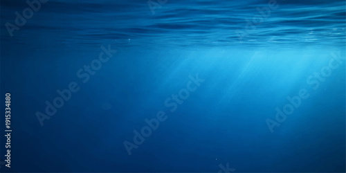 Sunlight rays pierce the deep blue ocean surface to create an abstract underwater scene where light reflections dance through the dark waves of the sea
