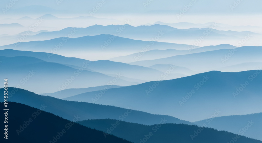 Obraz premium Majestic Blue Mountain Range Landscape with Rolling Hills and Misty Atmosphere