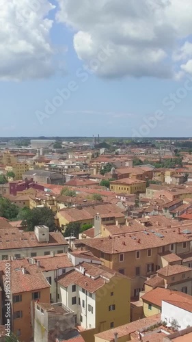 High angle drone shot of Lungarni Pisa on sunny summer day with green parks Arno water and Tuscan rooftops
