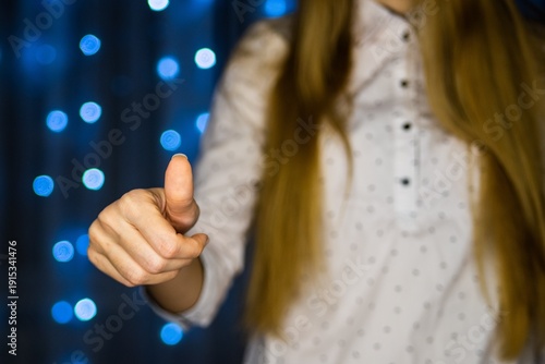 Woman giving thumbs up gesture indoors