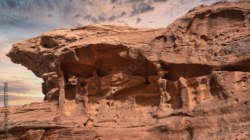 Ancient rock formations under a dramatic sky in Jordan desert