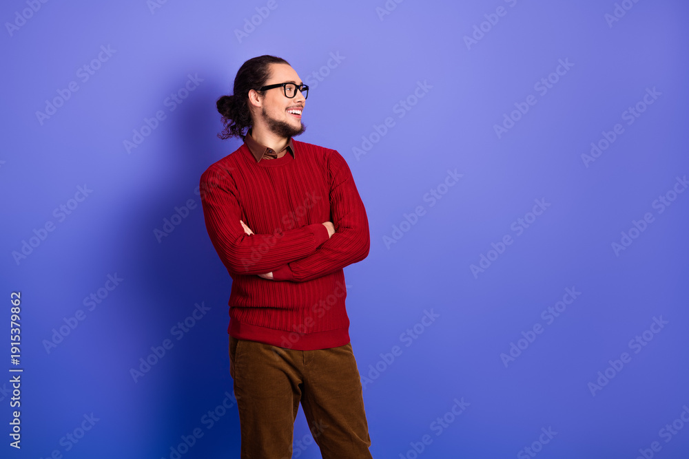 Fototapeta premium Young handsome man with glasses in red sweater posing against a violet background for lifestyle fashion and advertising photoshoot