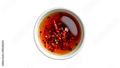 Overhead view of a small white bowl filled with spicy chili oil