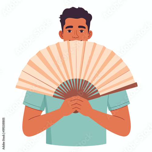 Man holding a traditional hand fan in front of his face, smiling