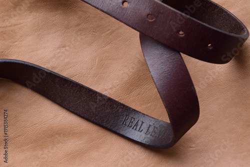 Bilde på lerret Brown leather belt on a brown leather background