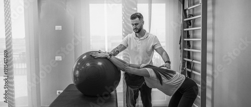 Wallpaper Mural Young woman receiving back physiotherapy exercises in a modern rehabilitation center Torontodigital.ca