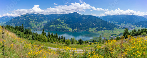 View of flowers, meadows and mountains from Plettsaukopf Reservoir on a sunny day, Bruckberg, Salzburg, Austria, Europe