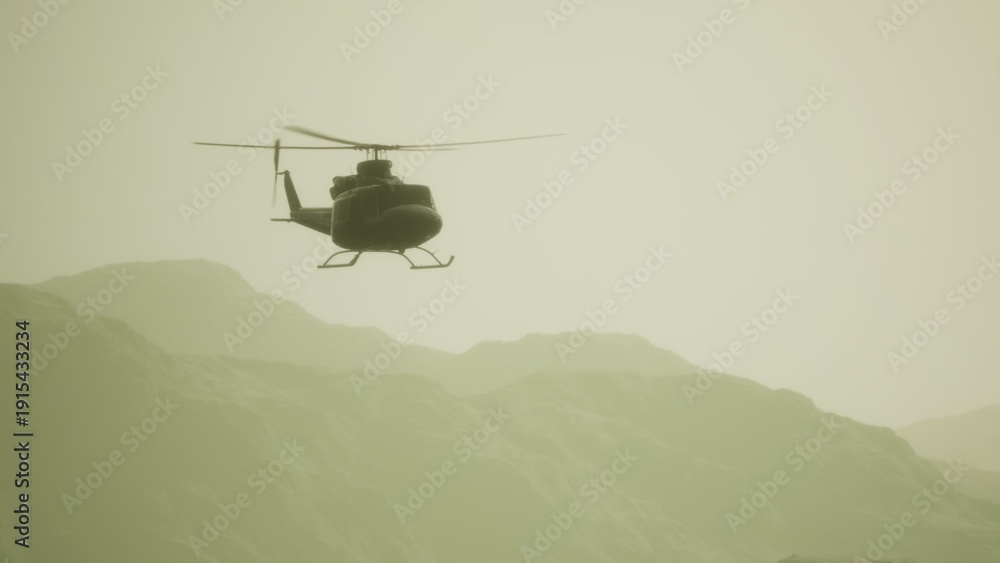 Fototapeta premium A helicopter glides smoothly through a hazy sky, its silhouette framed by distant mountains. The golden light of sunset bathes the landscape, creating a peaceful scene.