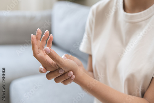 Health care and medical concept, rheumatism asian woman hand pain from cramp, trigger finger, wrist pain touching massaging, hand holding ache joint, arthritis inflammation.Chronic disease from injury