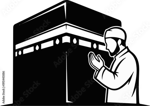 A man in a cap and robe prays with hands clasped before a cube-like structure