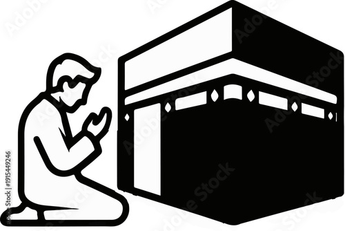 A person in prayer kneels beside a prominent cubical building