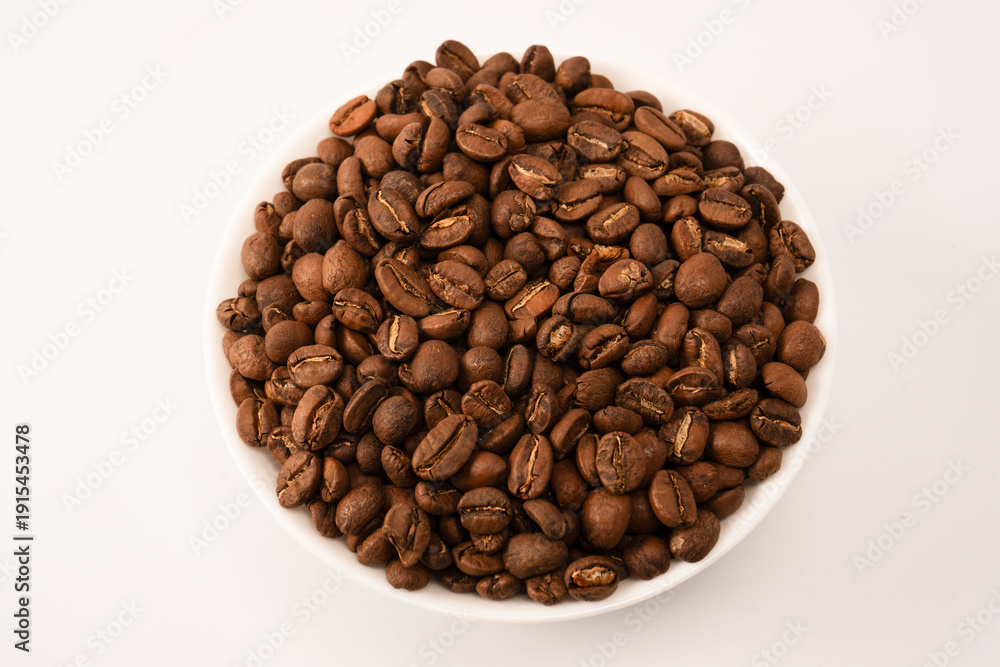 Fototapeta premium Coffee beans on a white background. Top view. Coffee beans texture.